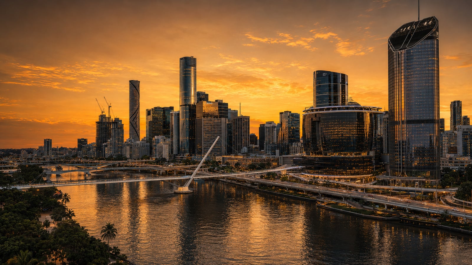 Brisbane riverfront skyline at dusk with pedestrian bridge and casino precinct
